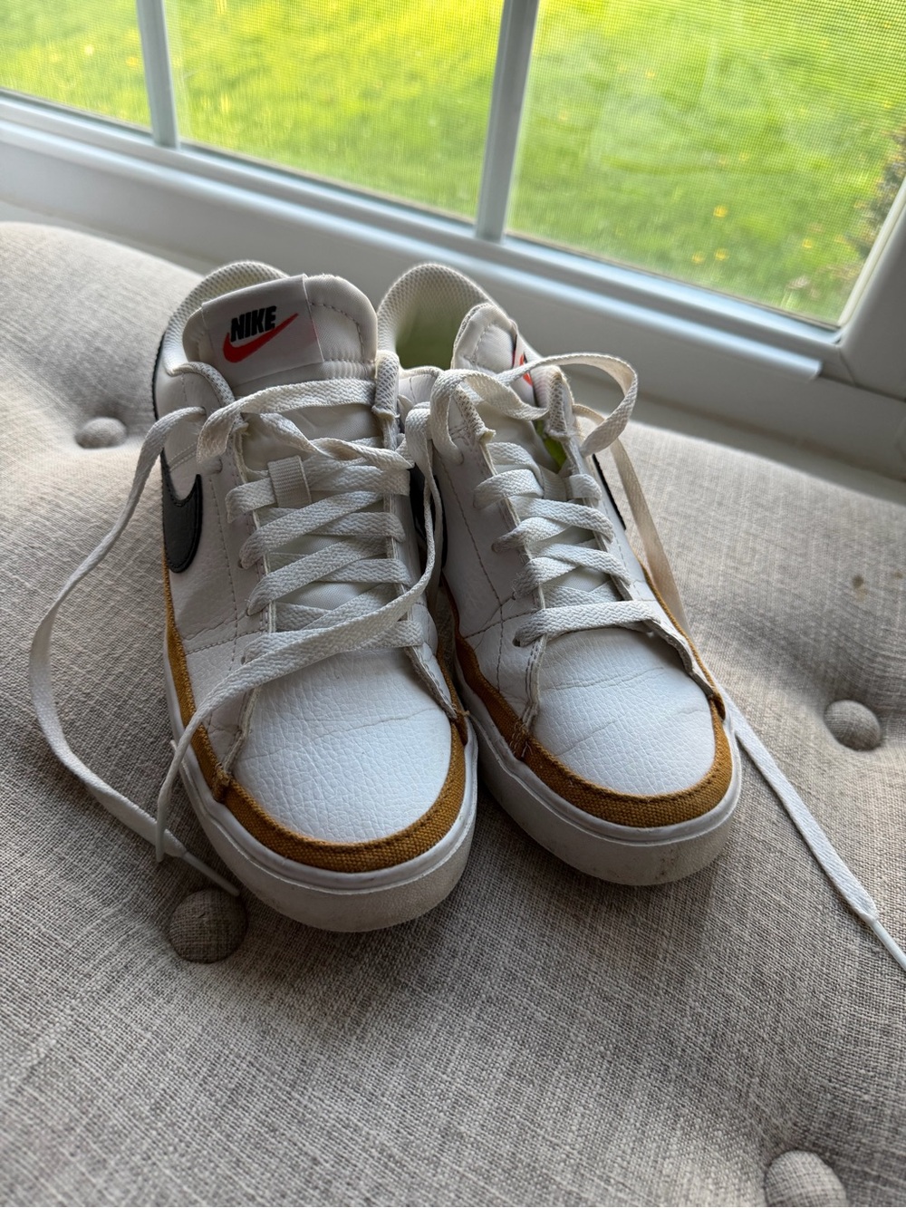 Nike White Low-Top Sneakers with Black Swoosh and Mustard Trim